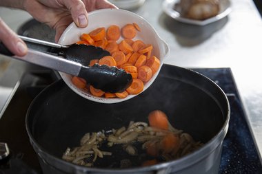 Add vegetables and herbs to the pan.