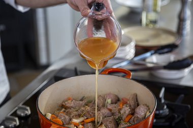 Add bouillon to the veal stew.