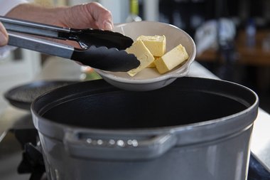 Put the butter in the pan.