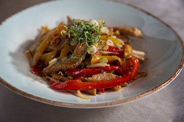 Enjoy the stir-fried veal strips.