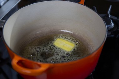 Put the butter in the pan.