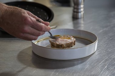 Pour the gravy over the veal roulade.