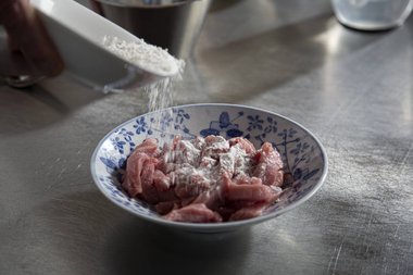 Dust the veal all around with tempura flour.